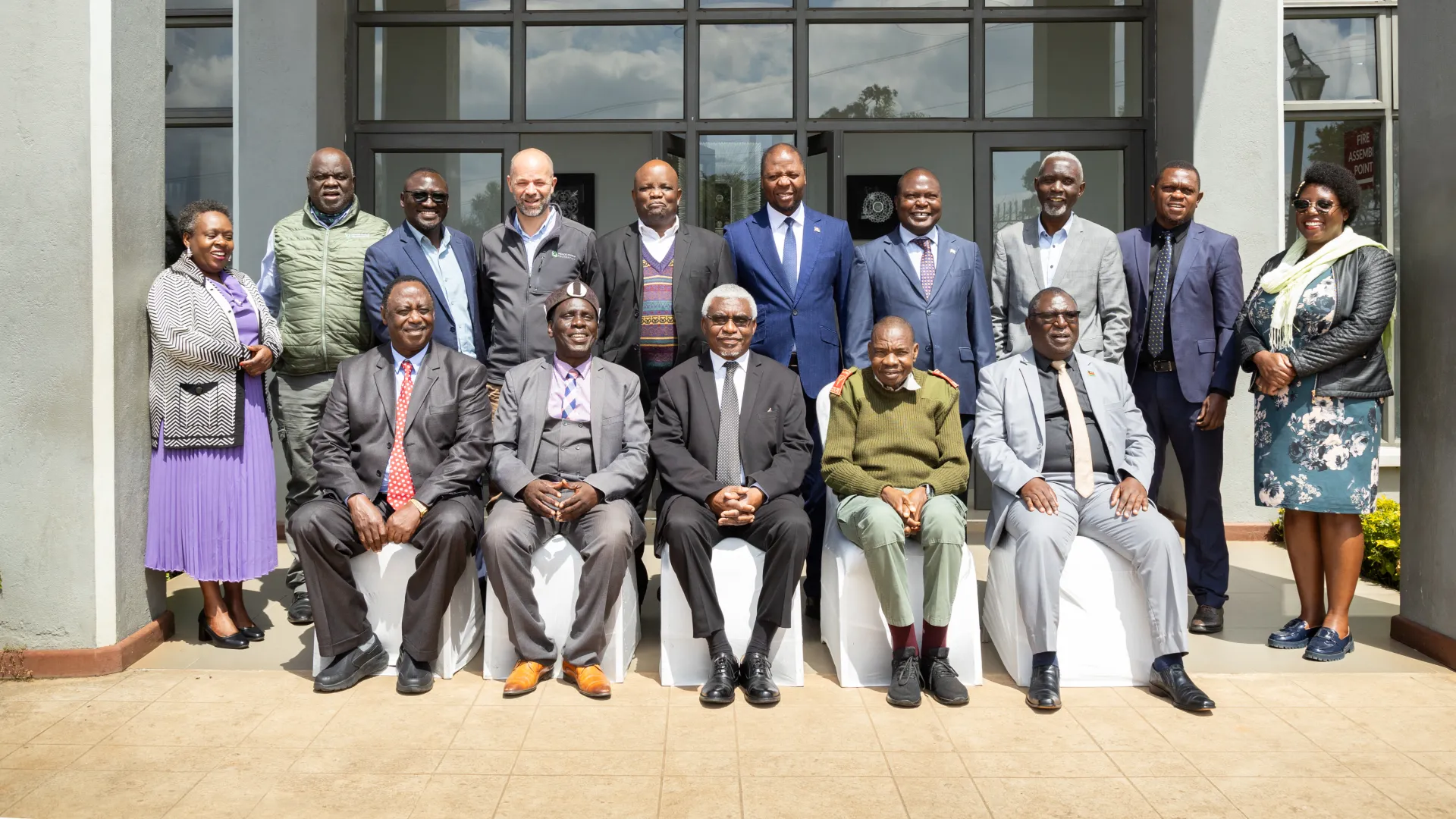 Nyika-Vwaza Independent Board members posing for a group photo outside a malawian government building.